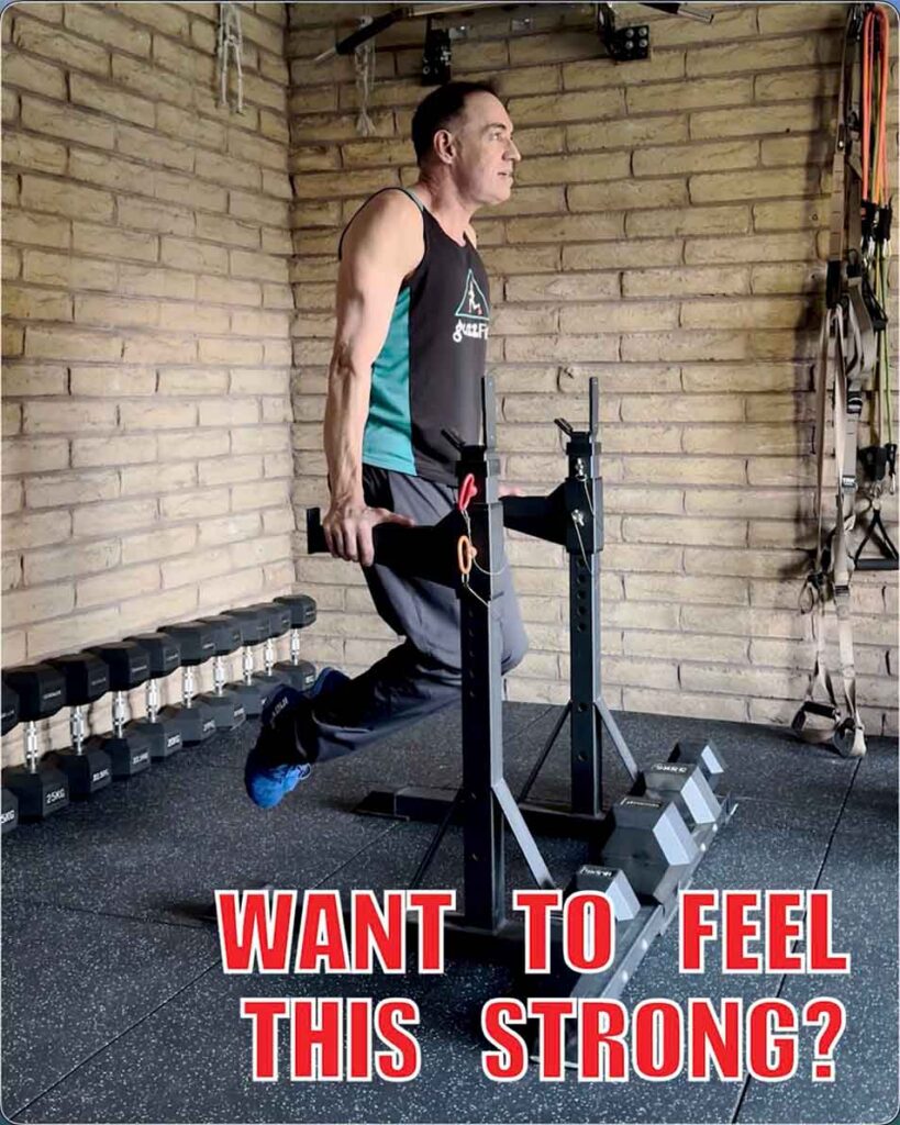 Trainer holding the top position of a bodyweight dip, with the words “Want to feel this strong?”